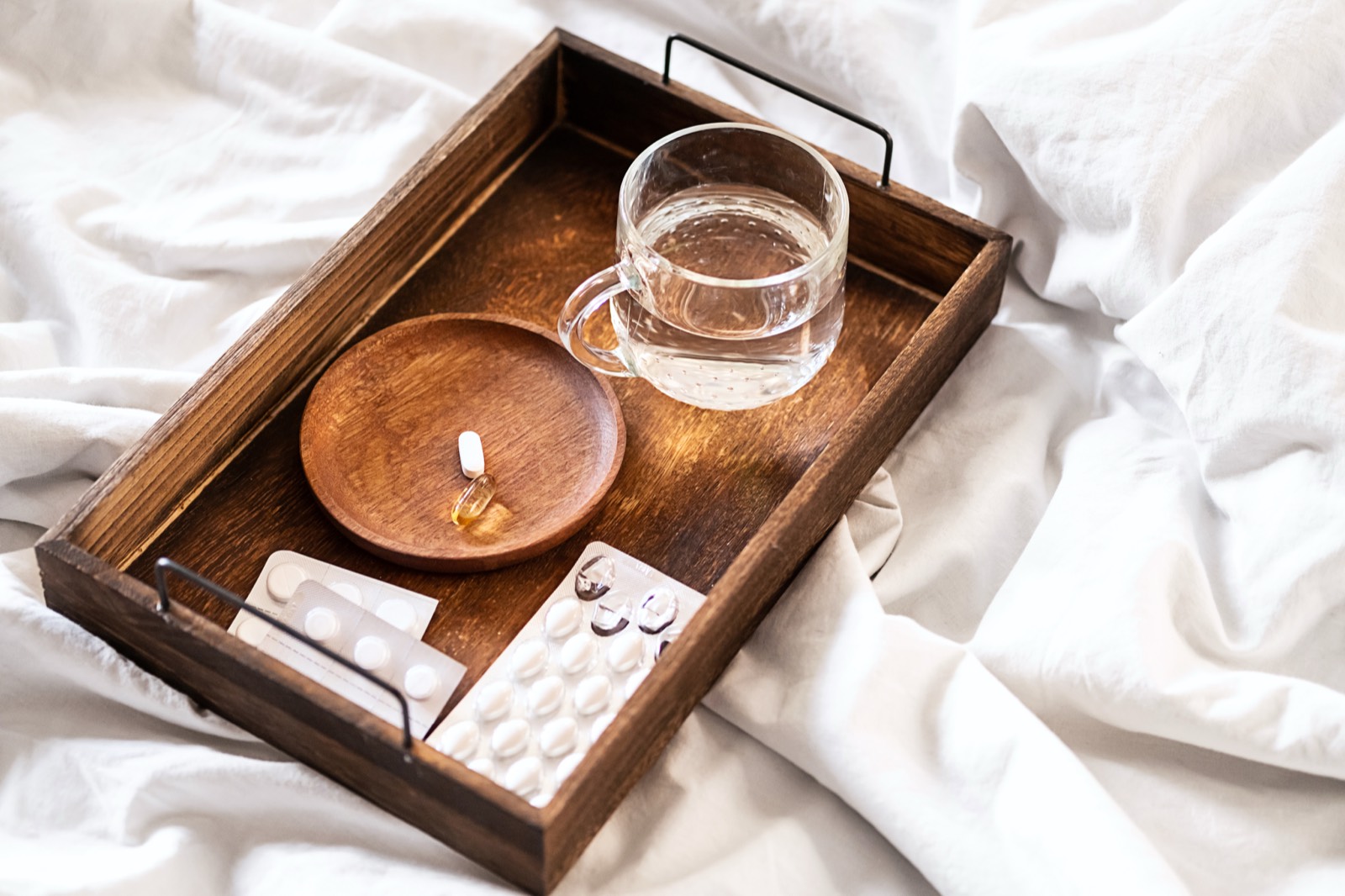 Supplements arranged on a wooden tray